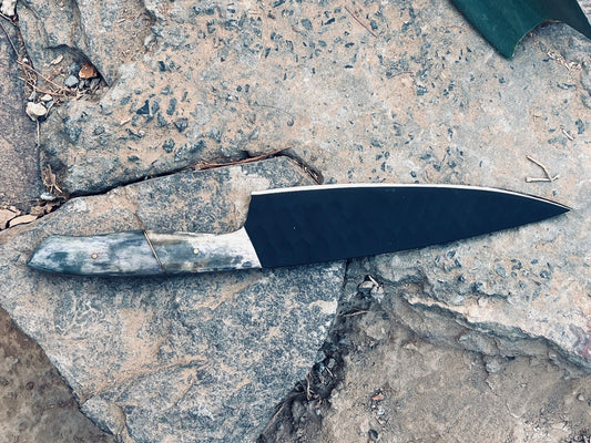 Chef knife in carbon coat with camel bone handle.